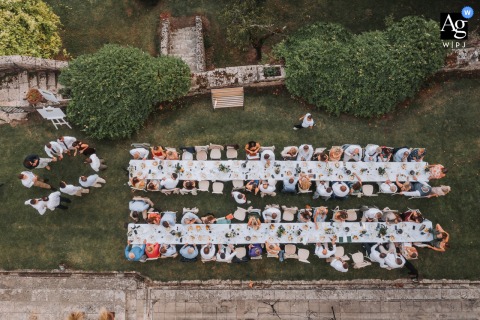 Overhead Angle Reveals The Newlyweds’ Table Decor At Chateau De Lisse In Réaup-Lisse, France During The Reception A view from above at Chateau de Lisse in Réaup-Lisse, Lot et Garonne, France, shows the newlyweds’ table, with delicate decor creating an elegant reception detail.