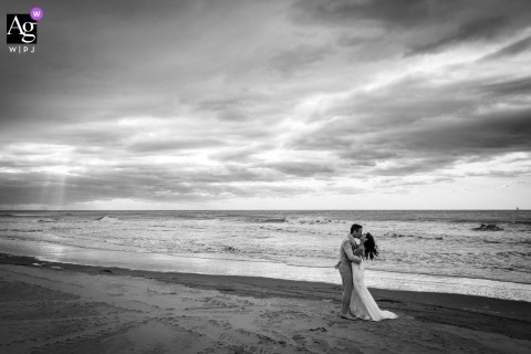 Along Ter Heide’s Makani Beach, The Couple’s Candid Portrait Captures Natural Scenery And Relaxed Joy On Their Wedding Day Along the shoreline near Makani Beach in Ter Heide, the couple is photographed together with the beach and venue environment creating a natural and relaxed backdrop for their wedding portrait.