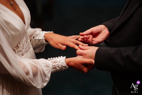 Couple Exchanges Rings During Ceremony At Hackney Town Hall London England During the ceremony at Hackney Town Hall in London, England, the couple participates in their ring exchange.