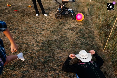   At Wolds Way Farm in Yorkshire, England, the reception scene features relaxed guests offering an inviting view of a countryside wedding celebration.