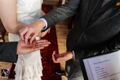   At Hause Hall in Cumbria, England, the best man presents the rings during the ceremony, a classic detail highlighting an essential tradition at the heart of the venue.