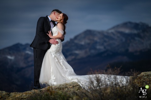 Bride Laughs As Groom Whispers Among Autumn Colors In Rocky Mountain National Park In Rocky Mountain National Park, Estes Park, Colorado, the bride bursts into laughter as the groom leans in to whisper something in her ear among autumn colors.