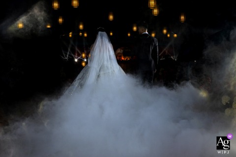 Bride And Groom Stand Together During Ceremony At Zhanjiang Guangdong Venue During their wedding ceremony at the venue in Zhanjiang, Guangdong, the bride and groom stand together, the ceremonial setting highlighting their commitment in a composed scene.