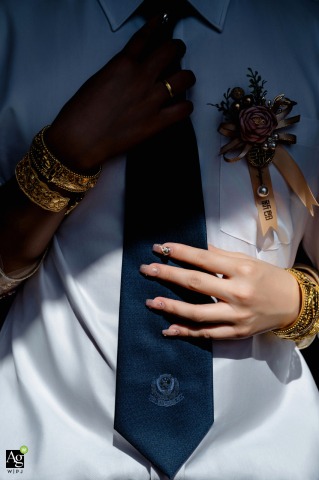 Bride Adjusts Groom’s Tie At Home In Zhanjiang Guangdong, Sunlight Fills The Room At home in Zhanjiang, Guangdong, the bride carefully adjusts the groom’s tie, sharing a quiet, affectionate exchange as sunlight brightens their space.