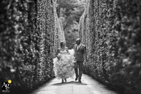 Couple Posed In Relaxed Portrait Among Tall Bushes In Noord Holland Park While walking through a park in Noord Holland, the couple is photographed in a relaxed portrait, surrounded by tall bushes that provides a natural and peaceful backdrop.