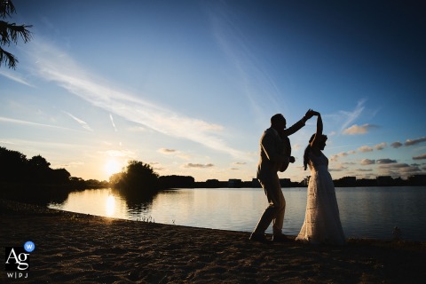 Couple Dances Barefoot On Sand At Sunset In Romantic Beach Portrait As the sun sets, the couple dances barefoot on the sand, the golden light and tranquil beach creating a romantic scene that celebrates their union.