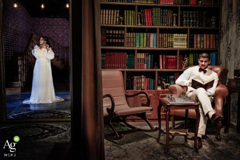 Groom Pauses for Portrait in Library Room at Istanbul Terrace Suleymaniye, Anticipating Wedding Traditions in Istanbul As the bride prepares for her day at Istanbul Terrace Suleymaniye, the groom pauses for a seated library room portrait, blending anticipation with tradition in this lively setting.