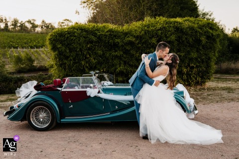 Couple Shares Passionate Kiss Before Reception At Domaine Des Palais Ambierle Loire At Domaine des Palais, Ambierle, Loire, just before entering the reception hall, the couple pauses for a passionate portrait kiss, highlighted by elegant surroundings in this expressive wedding portrait.