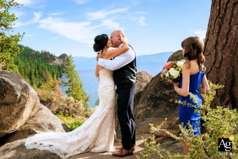 First Kiss At Lake Tahoe Overlook With Bridesmaid On a scenic overlook in South Lake Tahoe, the newlyweds share their first kiss, the breathtaking lake.
