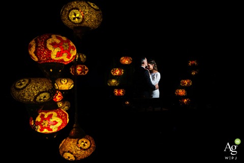 Vibrant Hanging Lanterns Illuminate Couple’s Portrait at Restaurante Tetería Meknes Rahma in Granada, Spain At Restaurante Tetería Meknes Rahma in Granada, Spain, the couple’s portrait is enhanced by the glow of vibrant hanging lanterns, creating a festive and colorful wedding scene.