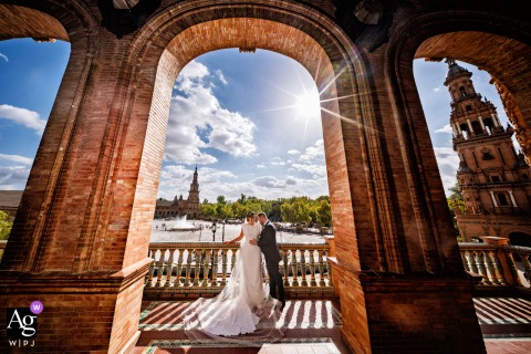   At Plaza de España in Sevilla, Spain, the couple was captured in a wedding portrait, the iconic architecture and vibrant setting highlighting this romantic Spanish city square.