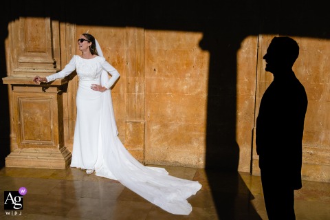 This artistic wedding portrait is taken at La Alhambra in Granada, Spain, blending the couple’s loving connection with the intricate details of the world-famous palace.