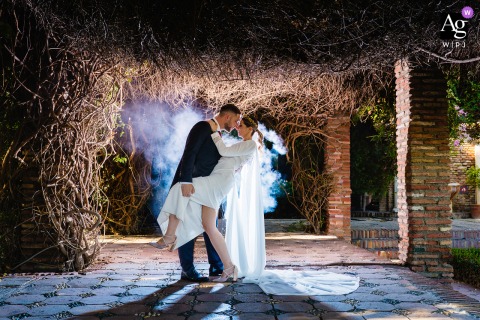 Timeless Romance Captured Amidst The Historic Walls Of Alcazaba De Málaga Spain The couple is photographed together at the historic Alcazaba de Málaga in Málaga, Spain, their portrait reflecting the ancient fortress’s timeless atmosphere and architectural beauty.