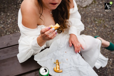 Bride Enjoys a Quiet Lunch at Gougane Barra Church in Ireland Before Heading Out for Wedding Photos Before heading off for wedding photos, the bride enjoys her lunch at Gougane Barra Church, savoring a quiet, bite after the ceremony.