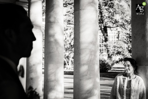 Couple Exchanges Sweet Glances Outside Grenoble Town Hall, France, During Their Black-and-White Portrait Session The couple spends time together just outside Grenoble town hall in France, exchanging sweet glances and quiet conversation during their bw portrait session.