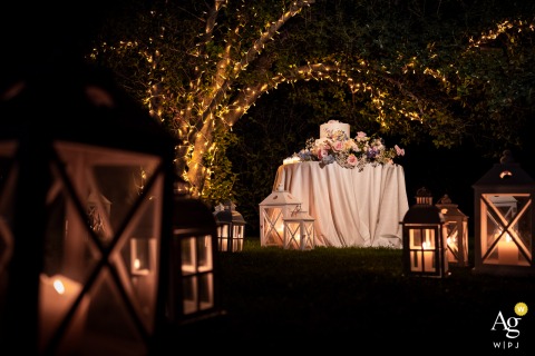 Festive Warmly Lit Cake Setup At Villa Dolceacqua In Oggiono Lake Como A warmly lit cake setup creates a festive atmosphere at Villa Dolceacqua in Oggiono, Lake Como, Italy, with elegant details highlighting the celebration’s inviting ambiance.