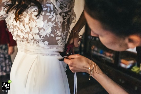 Wedding Dress-Cutting Scene with Gardening Tool at Domaine de Rebetz, Hauts-de-France, Adds Unexpected Fun A witness carefully cuts a piece from a wedding dress using a gardening tool at Domaine de Rebetz in Hauts-de-France, an unexpected and playful detail unfolding at the celebration.