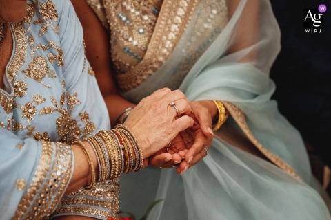 Heartfelt Wedding Ring Exchange Symbolizing Love In A Private Garden In Birmingham In a private garden setting in Birmingham, UK, hands exchange a wedding ring, symbolizing love and commitment during a heartfelt exchange.