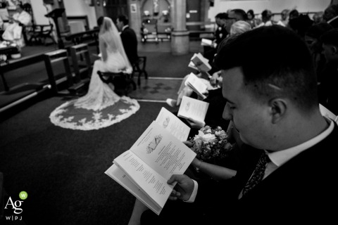 Traditional Vows Exchanged at Saint Mary’s on the Hill Catholic Church, Wednesbury, Surrounded by Loved Ones Guests gather in the pews of Saint Mary’s on the Hill Catholic Church in Wednesbury, UK, as the couple exchanges vows during a traditional wedding ceremony.