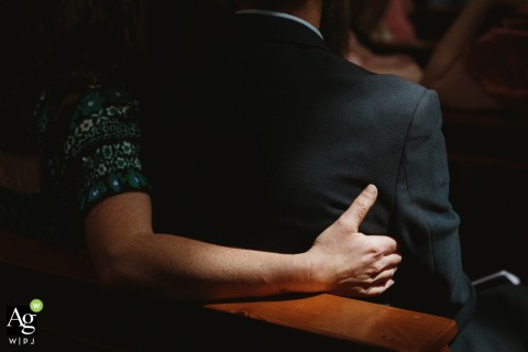 A Couple Embraces Amid Soft Light Inside Saint Mary’s on the Hill Catholic Church in Wednesbury, UK A couple shares a quiet embrace at Saint Mary’s on the Hill Catholic Church in Wednesbury, UK, the soft interior light highlighting their connection on their wedding day.