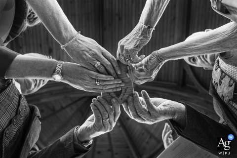 Warm Hands Protect The Wedding Rings At Dunlewey Church In County Donegal, Ireland At Dunlewey Church in County Donegal, Ireland, hands gently warm the wedding rings during the ceremony, creating a meaningful detail image that highlights care, anticipation, and the significance of the exchange.