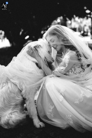 At the Grand Hotel Majestic on Lago Maggiore, Italy, the bride shares a tender black-and-white portrait with her beloved dog, their heads gently touching beneath the veil in a beautifully intimate wedding-day moment.