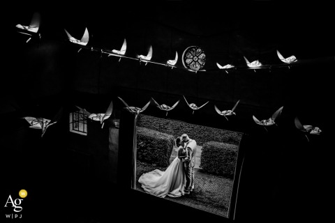 At De Bronckhorsthoeve in the Netherlands, the couple are seen through a creatively framed black-and-white display, where layered reflections and graphic composition transform a simple portrait into an artistic and visually striking image.