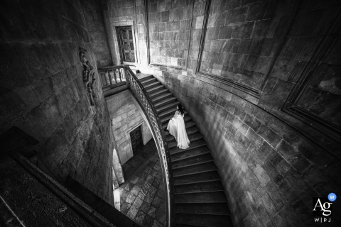 Grand Staircase Elegance Frames The Bride At La Alhambra In Granada, Spain At La Alhambra in Granada, Spain, the bride poses on the grand staircase, creating an elegant wedding-day portrait framed by the historic beauty and scale of the setting.