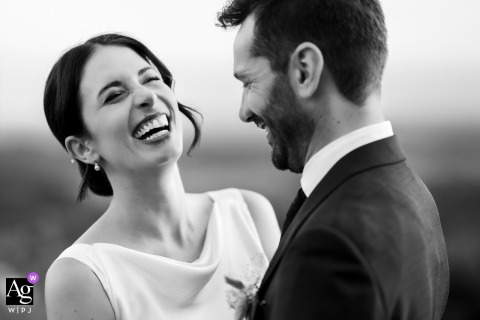 At Baronesse Tacco in San Floriano del Collio, Gorizia, Italy, the newlyweds laugh together during a black-and-white portrait session, creating a timeless image filled with genuine joy and connection.