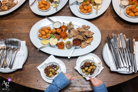 At The Libertine London in England, a young child stands in front of the wedding banquet, creating a charming moment that contrasts youthful curiosity with the elegant reception setting.