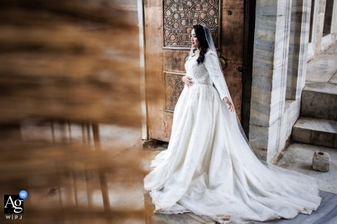 At the Blue Mosque in Istanbul, Türkiye, the bride is photographed in an elegant portrait, with the iconic architecture providing a timeless backdrop to the wedding-day image.