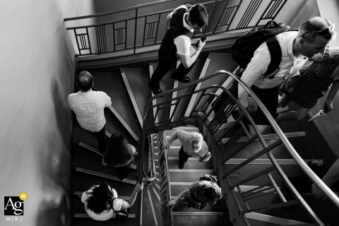 Wedding Guests Climb The Stairs At Entre-Deux-Guiers City Hall In Isère, France Together At Entre-deux-Guiers City Hall in Isère, France, wedding guests walk up the stairs toward the ceremony hall, capturing the quiet anticipation before the formal celebration begins.