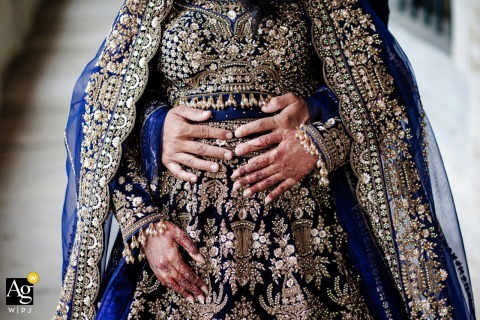 At the Blue Mosque in Istanbul, Turkey, the Pakistani wedding couple’s hands are photographed in close detail, highlighting their jewelry, attire, and cultural wedding traditions.