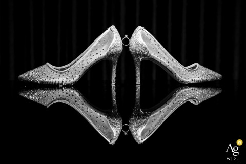 At Villa Maçakızı Hotel in Bodrum, Türkiye, the bride’s shoes and wedding ring rest on a reflective surface, creating an elegant detail photograph with striking symmetry and mirrored reflections.