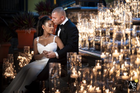 At Zephyr Palace at Villa Caletas Hotel in Jacó, Costa Rica, the bride and groom share a romantic nighttime portrait surrounded by glowing candlelight, creating an intimate and elegant wedding-day scene.
