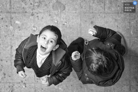Perugia Wedding Photojournalism | Image contains: kids bubbles playing reception