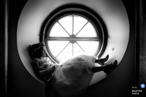 Rheinland-Pfalz Wedding Photographer | Image contains: little girl dress sitting round window