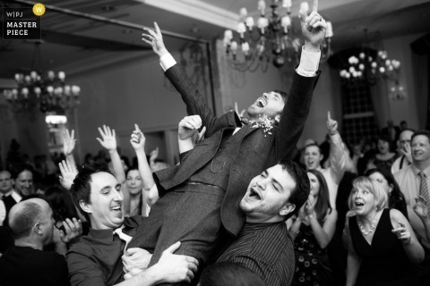 New Jersey wedding black and white photo of a celebrating groom being lifted into the air by his groomsmen