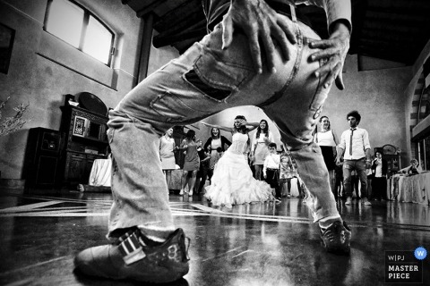 A Bergamo groom's buns on display during the wedding dance in an amusing black and white candid