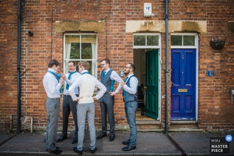 The groomsmen stand outside getting ready for the ceremony in this award-winning image by a Manhattan, NY wedding photographer The groomsmen stand outside getting ready for the ceremony in this award-winning image by a Manhattan, NY wedding photographer.