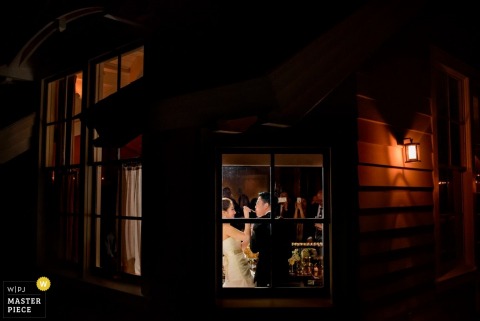 The bride and groom feed each other cake at the Charleston reception - South Carolina wedding photojournalism 