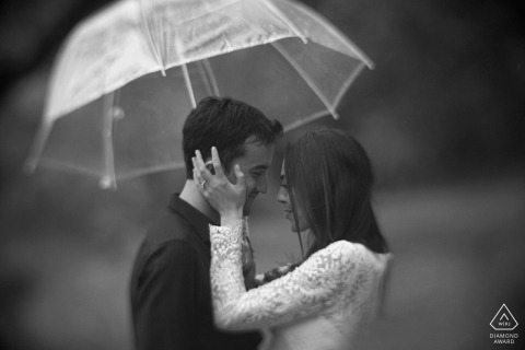 A Bronx couple during their pre-wedding portrait session in the rain with umbrella | New York  photographer