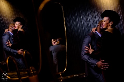 Chicago Engagement Photographer. Multiple reflections of this couple embracing indoors.