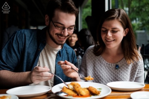 Atlanta Georgia couple share a meal together at a restaurant during their engagement shoot Atlanta Georgia couple share a meal together at a restaurant during their engagement shoot