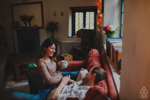 Indoor engagement session on the couch with a coffee for this pre-wedding shoot in England