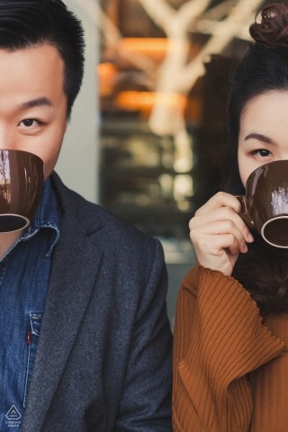 Vertical engagement photos of a couple drinking from coffee / tea cups  | Hangzhou photographer pre-wedding portrait session