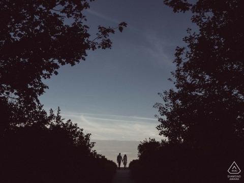 Portland Maine Engagement Photo of a couple near dusk with big sky and big trees