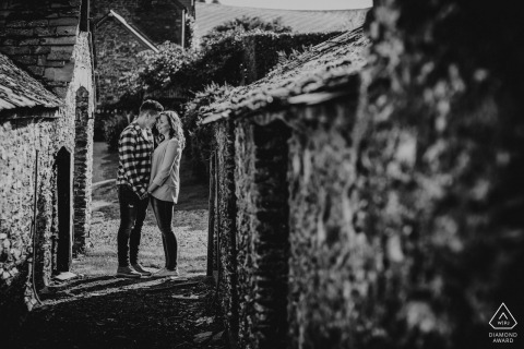 England black and white pre-wedding engagement pictures of a couple in a brick and stone alley  | Devon portrait shoot