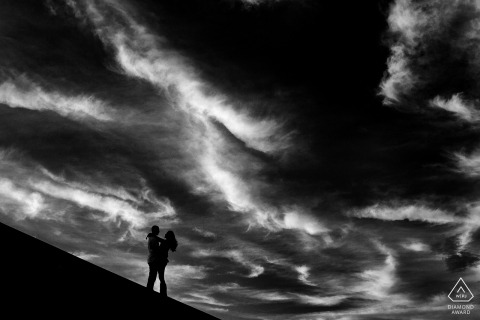 Lake Tahoe pre-wedding engagement pictures of a couple with dark sky | California black and white couple photography session