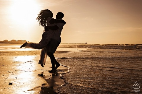 The North Carolina couple dancing at the shore of the ocean during sunset